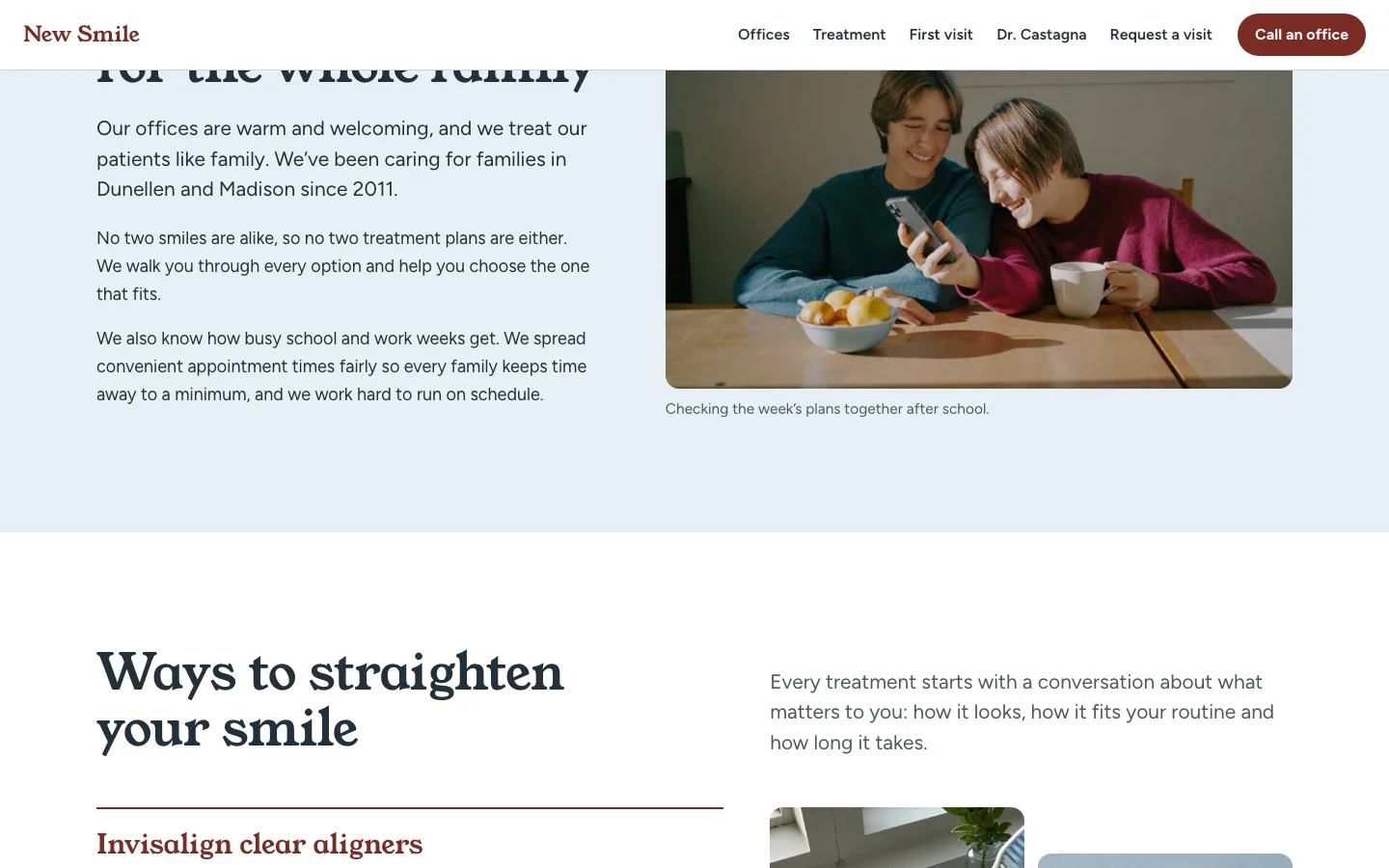 New Smile about section on a pale blue ground: two people checking a phone together at a kitchen table, beside a short introduction.